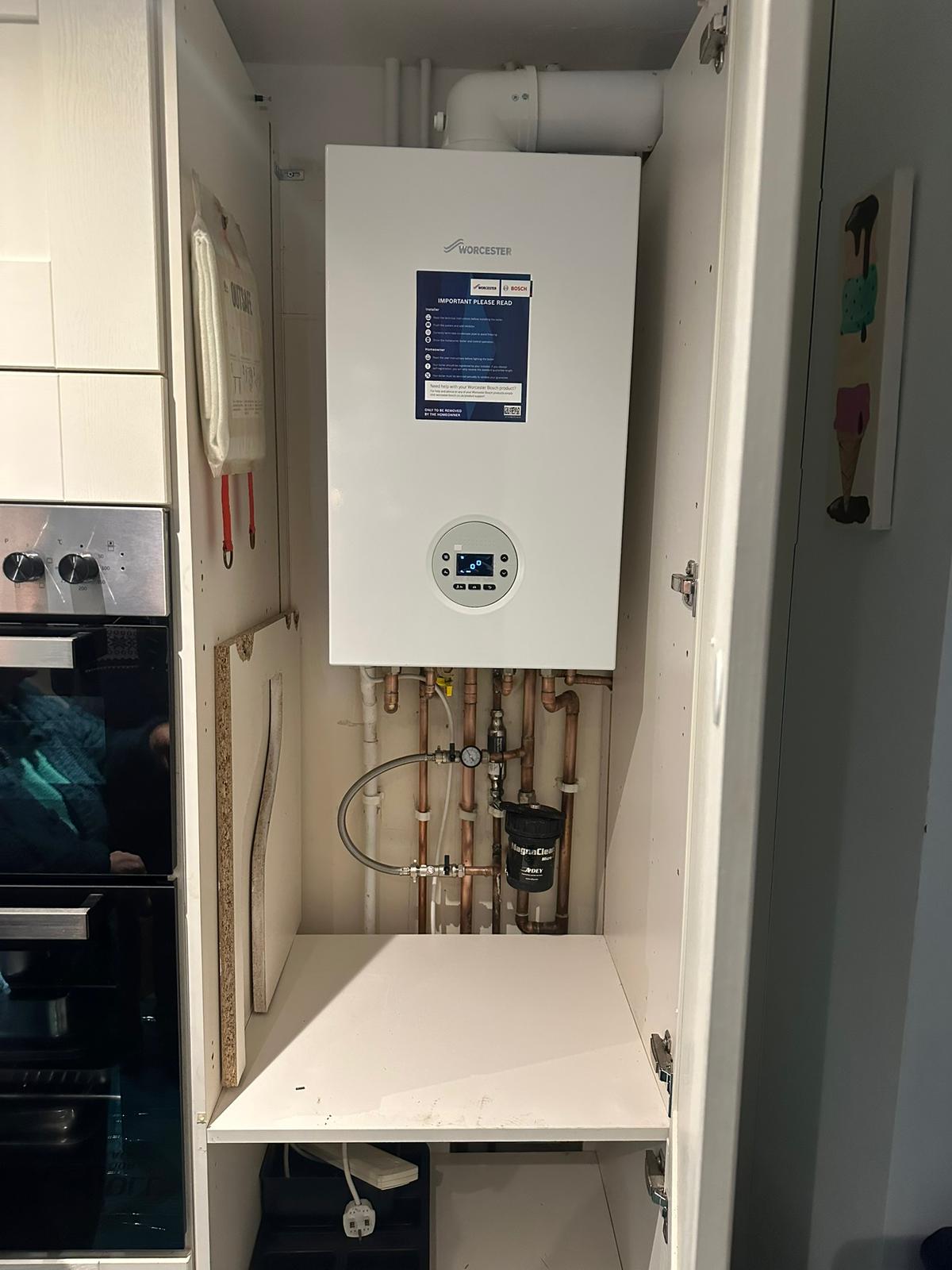 Engineer servicing a Worcester combi boiler